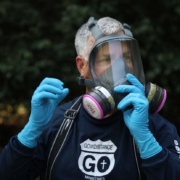 Break the Mold expert putting on protective equipment before entering a home with mold.