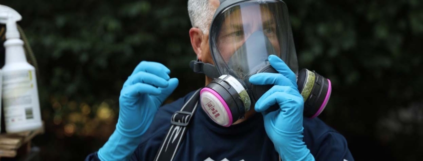 Break the Mold expert putting on protective equipment before entering a home with mold.